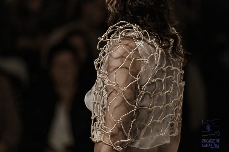 Close-up of a hand-knotted cream mesh bodice over sheer fabric, from the Acqua Vitae collection.
